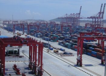 Shipping containers stacked at a Chinese port, a driver of the China economy through 2026