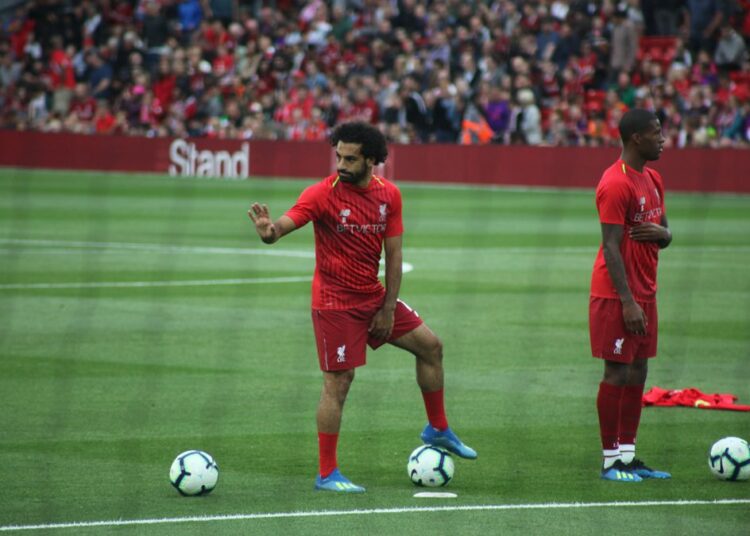 Mohamed Salah warming up in a Liverpool training kit before a match