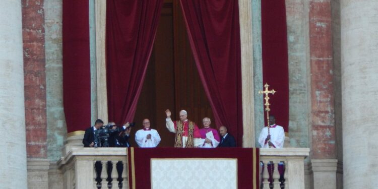 Pope Leo XIV waving from the loggia of St. Peter's Basilica after his election