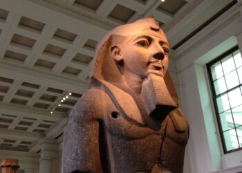 Colossal granite Ramses II statue bust from Thebes in a museum hall