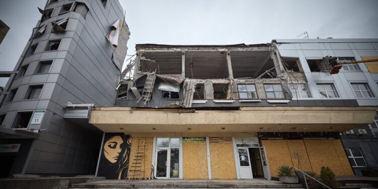 A building in Zaporizhzhia with its upper floors torn open by an earlier Russian strike